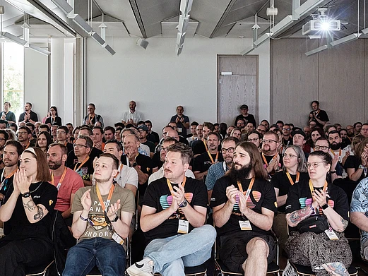 Audience of developers attending a talk at TYPO3 Developer Days 2025 in Karlsruhe, gathered to learn, network, and exchange knowledge within the TYPO3 community.