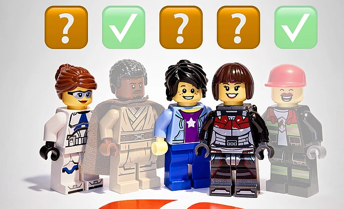 Five LEGO minifigures stand in a row, each under a symbol; three have orange question marks above them, and two have green check marks above them and are slightly transparent. Light gray background and a TYPO3 logo on the ground.