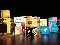 Colorful TYPO3 booth setup at an event.