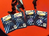 Four Forum PHP Paris 2026 conference badges with lanyards on orange background