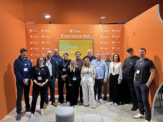 Group of partner representatives attending SCCON inside the TYPO3 Experience Hub booth at DMEXCO.