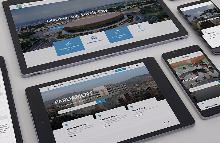 Multiple devices displaying Kigali City and Parliament websites with aerial city views and blue navigation elements