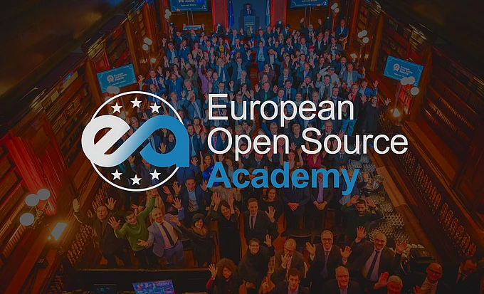 European Open Source Academy logo and text overlaid on aerial view of large diverse crowd gathered in ornate red hall with blue banners