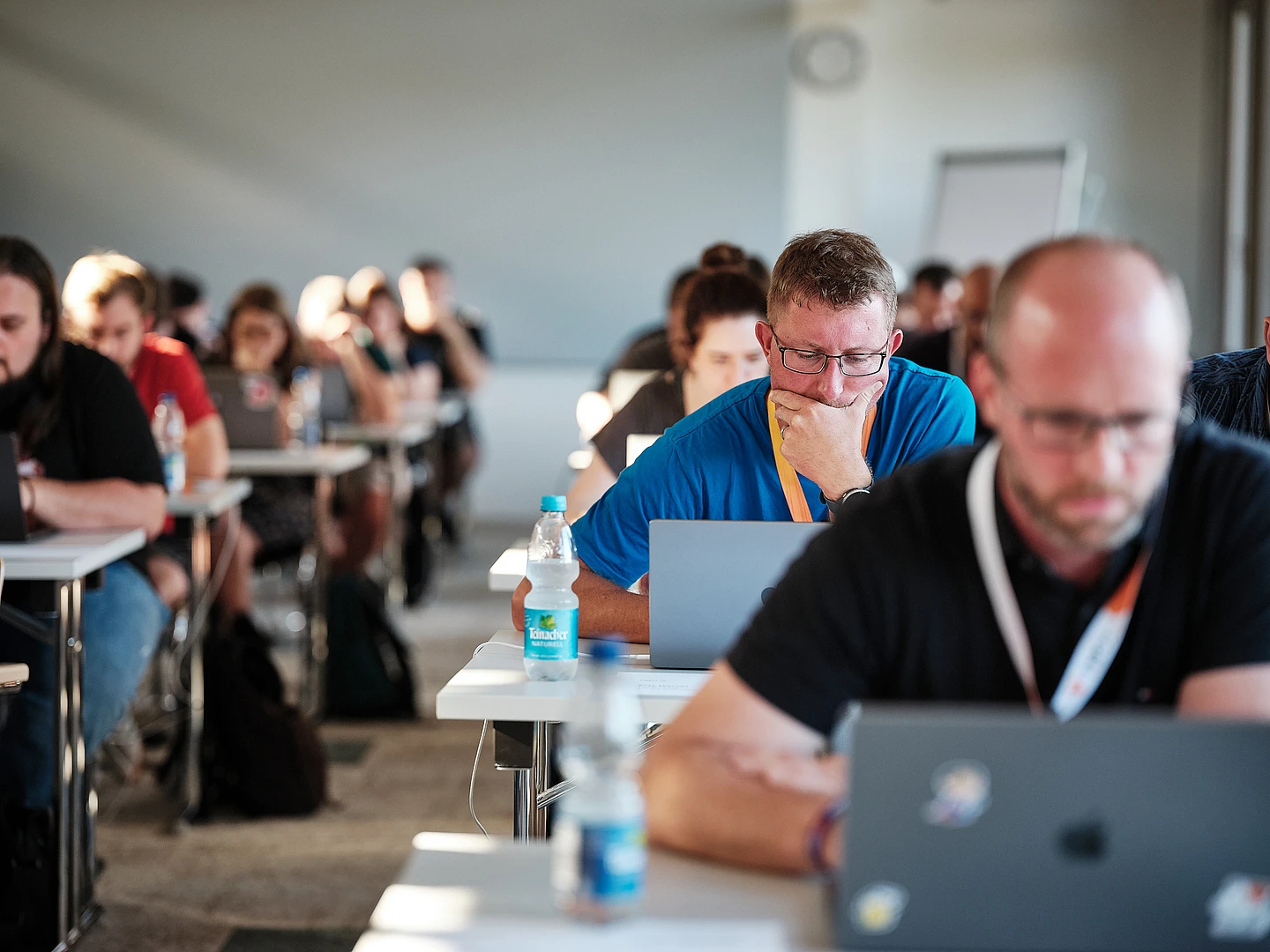 People focused on laptops during certfication