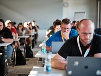 People focused on laptops during certfication